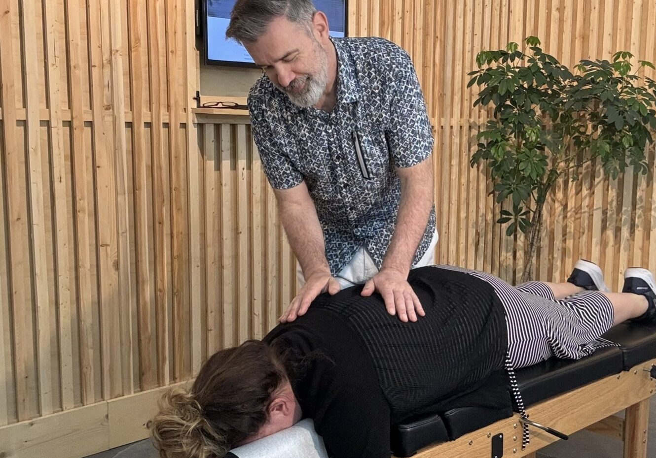 Dr Case adjusting a woman at the chiropractic studio in chilliwack